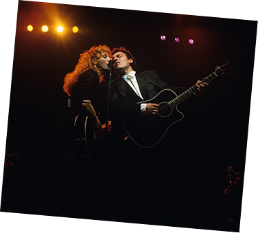Bruce Springsteen and Patti Scialfa singing on stage